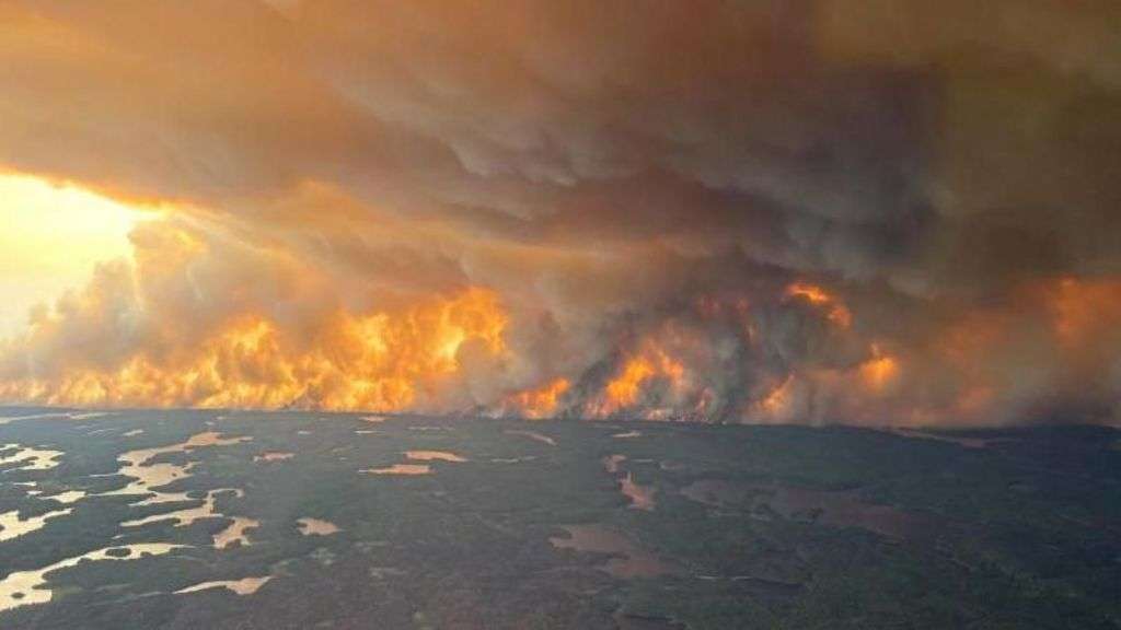 Thousands flee wildfire in Manitoba as 'out of control' blazes burn across Canada